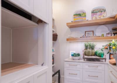 Photo of a brand new pantry with a custom dumbwaiter built by lanphear builders