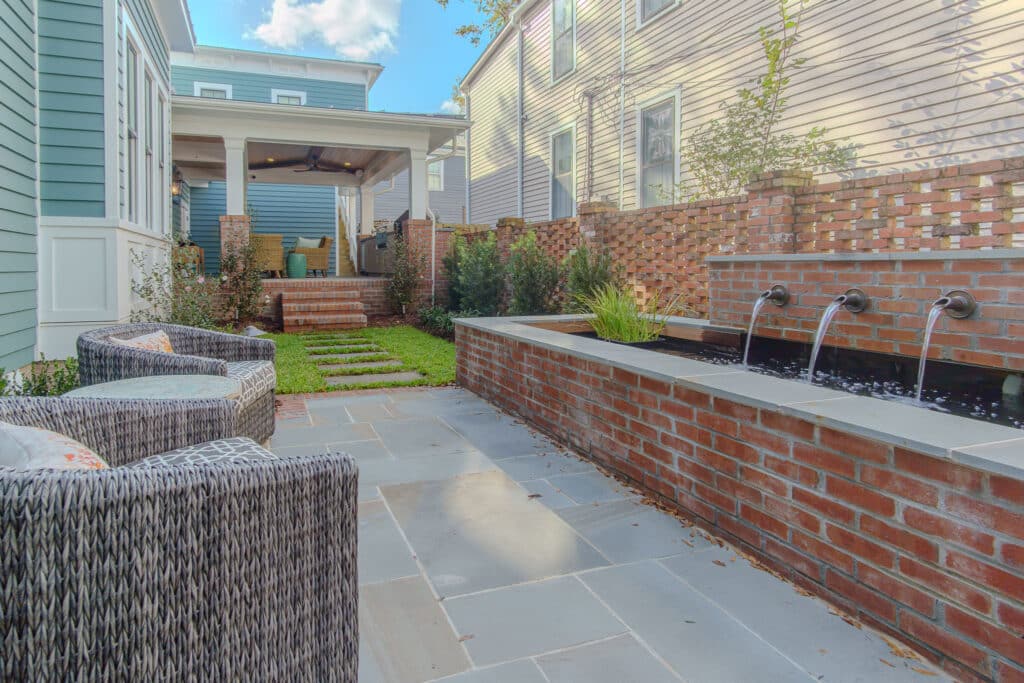 Photo of A Serene Outdoor Space including a Brick Water Feature on this Historic Downtown Renovation