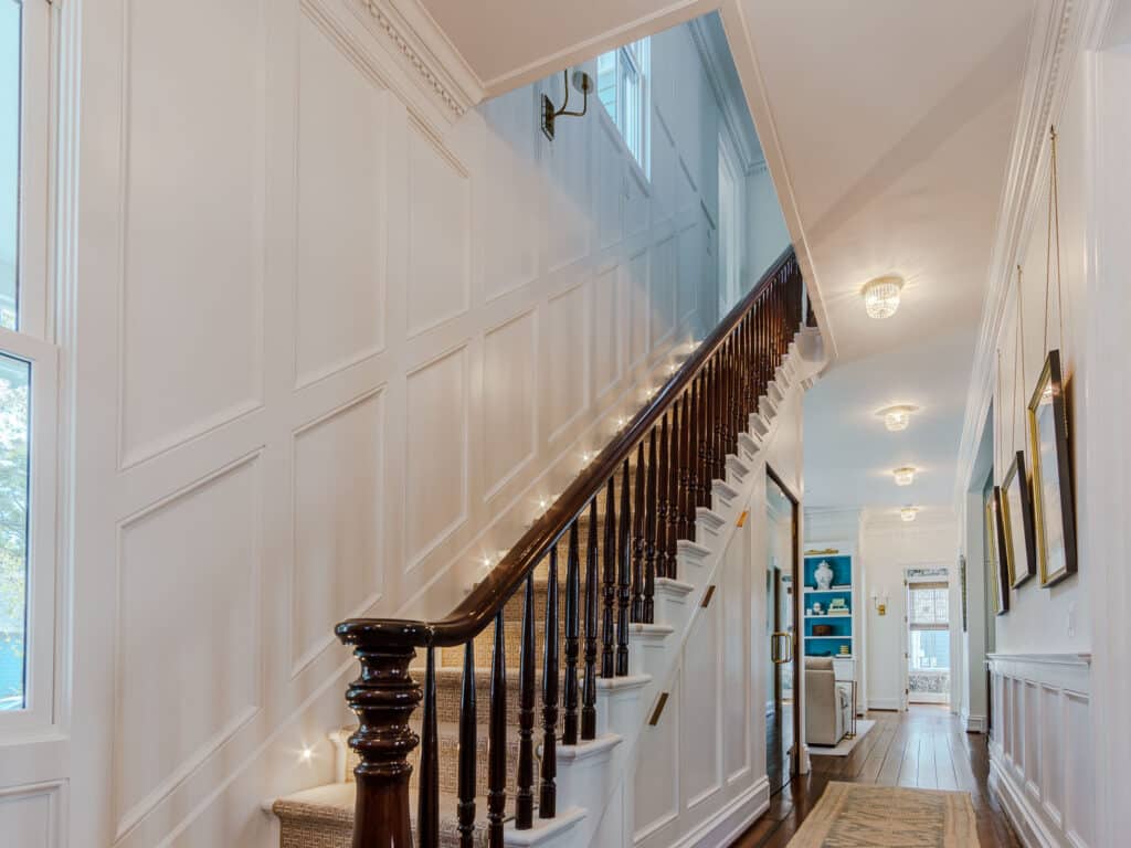 Photo of Original Staircase and Intricate Wainscoting and Moldings for Historic Home