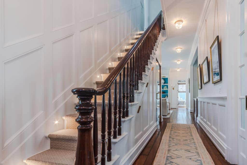 Photo of Original Staircase and Intricate Wainscoting and Moldings for Historic Home